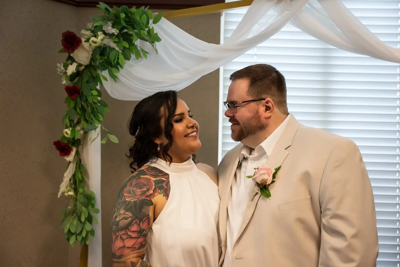Wedding ceremony photography under a floral drape