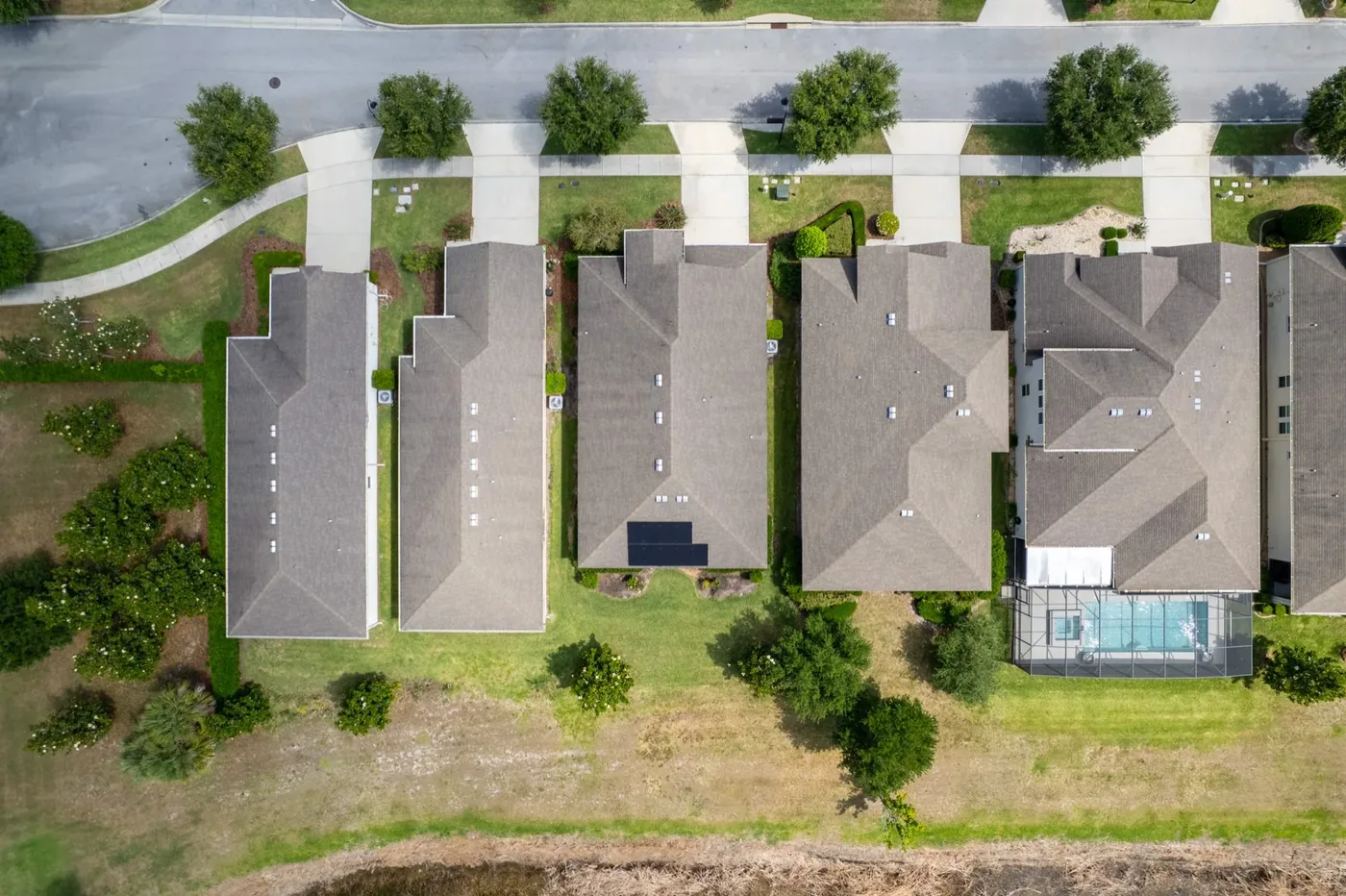 Aerial drone photography of lakefront golf community real estate